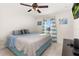 Bright bedroom with a ceiling fan, a large bed, and a window with curtains at 825 Desmoines Pl, Kissimmee, FL 34759