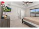 Main bedroom with king bed, TV, and dresser at 825 Desmoines Pl, Kissimmee, FL 34759