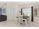 Casual dining area with a table and chairs near a doorway and window at 825 Desmoines Pl, Kissimmee, FL 34759