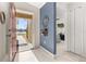 Bright entryway with red door and view into the living room at 825 Desmoines Pl, Kissimmee, FL 34759