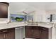 Modern kitchen with dark cabinets, granite countertops, and stainless steel appliances at 825 Desmoines Pl, Kissimmee, FL 34759