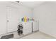 Convenient laundry room with washer, dryer, and storage at 825 Desmoines Pl, Kissimmee, FL 34759