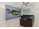 Living room with sectional sofa, ceiling fan, and accent wall at 825 Desmoines Pl, Kissimmee, FL 34759