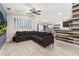 Open living room with sectional sofa and view of kitchen at 825 Desmoines Pl, Kissimmee, FL 34759