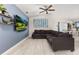 Spacious living room with sectional sofa and large TV at 825 Desmoines Pl, Kissimmee, FL 34759