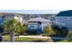Modern single-story house in a community setting with palm trees and sidewalks at 8664 Dubochet St, Orlando, FL 32827