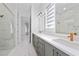 Double vanity bathroom with marble tile and walk-in shower at 8664 Dubochet St, Orlando, FL 32827