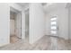 Modern entryway with light flooring and a frosted glass door at 8664 Dubochet St, Orlando, FL 32827