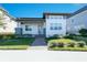 Modern single-story home with gray and white exterior, landscaping, and paved walkway at 8664 Dubochet St, Orlando, FL 32827