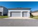 Two-car garage with gray doors and driveway at 8664 Dubochet St, Orlando, FL 32827