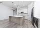 Modern kitchen with stainless steel appliances and white cabinetry at 8664 Dubochet St, Orlando, FL 32827
