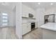 Modern kitchen with stainless steel appliances and white cabinetry at 8664 Dubochet St, Orlando, FL 32827