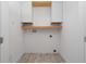 Laundry room with wooden countertop and white cabinets at 8664 Dubochet St, Orlando, FL 32827