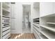 Bright walk-in closet with built-in shelving and drawers at 8664 Dubochet St, Orlando, FL 32827