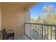 Balcony with a chair and tranquil wooded view at 879 Assembly Ct, Reunion, FL 34747
