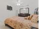 Full-size bedroom with TV and dresser at 879 Assembly Ct, Reunion, FL 34747