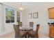 Small breakfast nook with glass table and wicker chairs at 879 Assembly Ct, Reunion, FL 34747