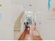 Bright entryway with hardwood floors and staircase at 879 Assembly Ct, Reunion, FL 34747