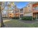 Townhouse with balcony, screened porch, and landscaping at 879 Assembly Ct, Reunion, FL 34747