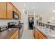 Modern kitchen with stainless steel appliances and wood cabinets at 879 Assembly Ct, Reunion, FL 34747