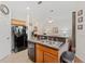 Kitchen features wood cabinets, black appliances, and a breakfast bar at 879 Assembly Ct, Reunion, FL 34747