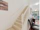 White staircase with carpeted steps and railing at 879 Assembly Ct, Reunion, FL 34747