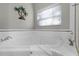 Corner soaking tub with window in a bright bathroom at 901 New Providence # B20/U901, Davenport, FL 33897