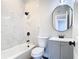 Updated bathroom with marble tile, gray vanity, and modern fixtures at 101 Gerry Dr, Altamonte Springs, FL 32714