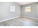 Bedroom with gray walls, wood-look flooring and two windows at 101 Gerry Dr, Altamonte Springs, FL 32714