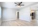 Open concept living room with wood-look floors and view into updated kitchen at 101 Gerry Dr, Altamonte Springs, FL 32714