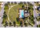 Aerial view of community pool, clubhouse, playground, and surrounding green space at 1721 Sunfish St, St Cloud, FL 34771