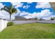 Spacious backyard with grassy lawn and white fence at 1721 Sunfish St, Saint Cloud, FL 34771