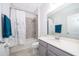 Bathroom with grey vanity, tub shower, and white floral curtain at 1721 Sunfish St, St Cloud, FL 34771