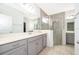 Bathroom with gray vanity and a large walk-in shower at 1721 Sunfish St, St Cloud, FL 34771