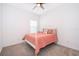 Bedroom with coral bedding and ceiling fan at 1721 Sunfish St, St Cloud, FL 34771