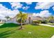 Landscaped front yard with palm trees and a brick driveway at 1721 Sunfish St, St Cloud, FL 34771