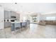 Open kitchen with gray cabinets, an island, and tile floors at 1721 Sunfish St, St Cloud, FL 34771