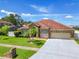 Brick house with a two-car garage and palm trees in the front yard at 1918 Crosshair Cir, Orlando, FL 32837