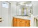 Clean bathroom with wood vanity, single sink, and shower at 1960 Jan Lan Blvd, St Cloud, FL 34772