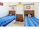 Bedroom with twin beds and shared bathroom at 204 Fox Loop, Davenport, FL 33837
