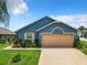 Charming one-story home with a two-car garage and well-maintained landscaping at 204 Fox Loop, Davenport, FL 33837