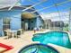Private backyard oasis with a large pool, spa, and patio furniture at 204 Fox Loop, Davenport, FL 33837