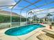 Inviting screened-in pool and spa with lounge chairs for relaxation at 204 Fox Loop, Davenport, FL 33837