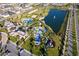 Aerial view of a community with pools, a lake, playground, and other amenities at 2166 Fleming Mist Pl, Kissimmee, FL 34747