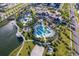 Aerial view of community pool, clubhouse, and surrounding landscape at 2166 Fleming Mist Pl, Kissimmee, FL 34747