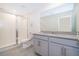 Bathroom with gray vanity, shower, and tile floor at 2166 Fleming Mist Pl, Kissimmee, FL 34747