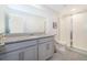 Bathroom with gray vanity, shower, and tile floor at 2166 Fleming Mist Pl, Kissimmee, FL 34747