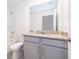 Bathroom with gray vanity, toilet and tub at 2166 Fleming Mist Pl, Kissimmee, FL 34747
