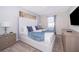 Bedroom with a white upholstered bed, gray nightstands, and a blue throw blanket at 2166 Fleming Mist Pl, Kissimmee, FL 34747