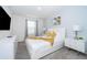 Bedroom with a queen bed and yellow throw blanket, modern nightstands and a TV at 2166 Fleming Mist Pl, Kissimmee, FL 34747